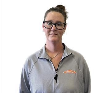 Crew Chief Mindi Parker smiling with a white wall in the background.