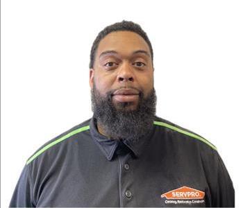 Male employee smiling against a white background.