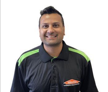 Male employee smiling against a white background.