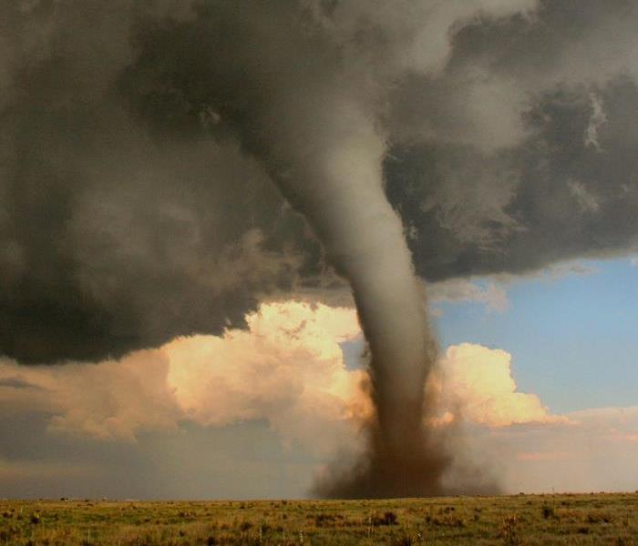 Tornado touches down in the fields of a rural area. 